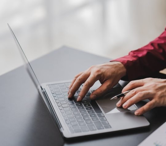 Close-up of printing data check data on laptop